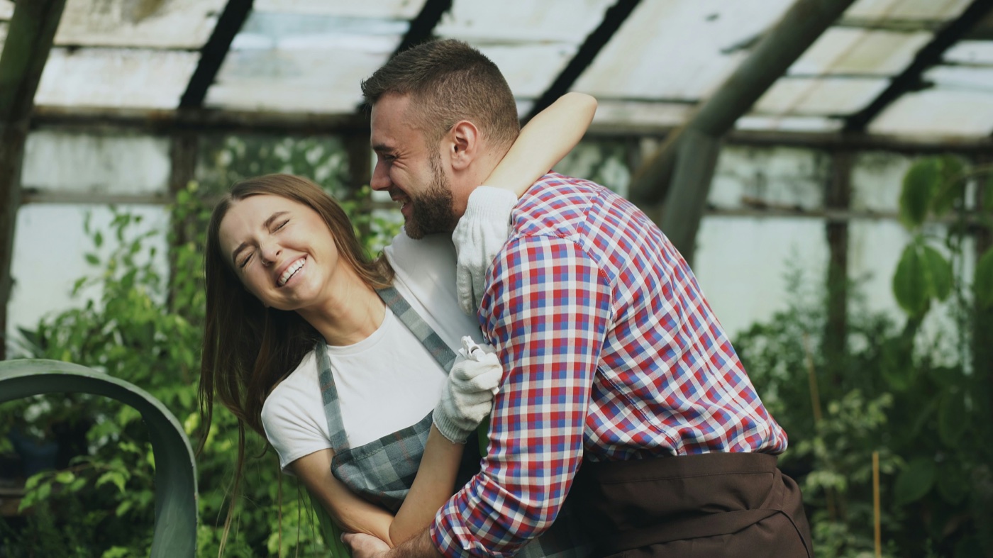 A couple holding hands and smiling